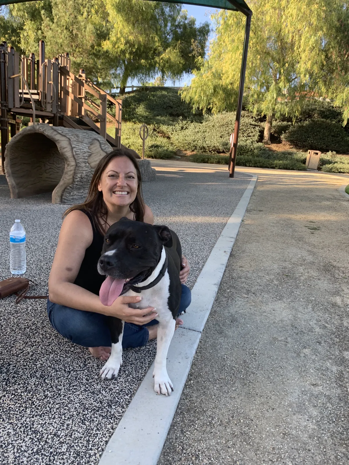 Eco Paw Spa groomer with a happy black and white dog