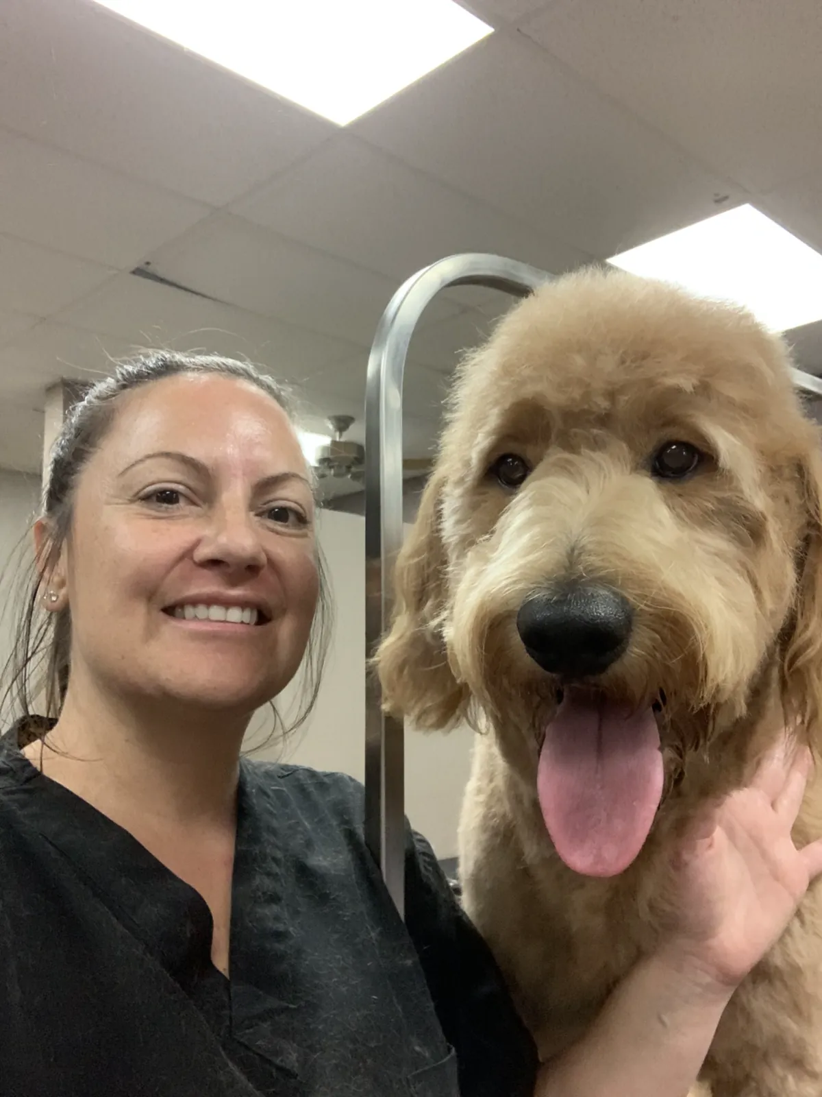 Eco Paw Spa groomer with a happy freshly groomed doodle